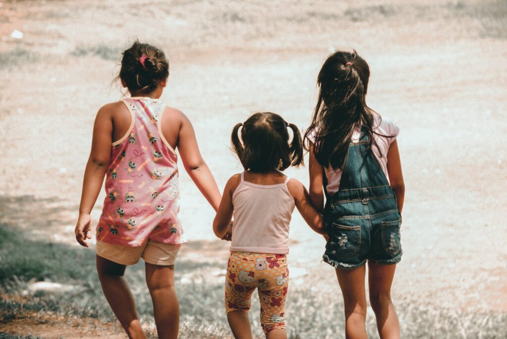 immigrant children holding hands together